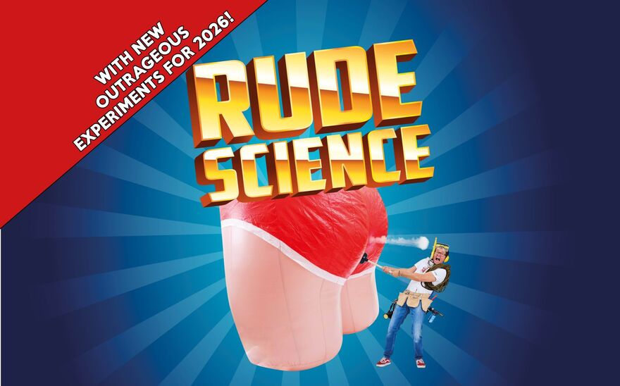 A man stands next to a large inflatable bottom with red pants on and the text 'Rude Science' is overlayed on top