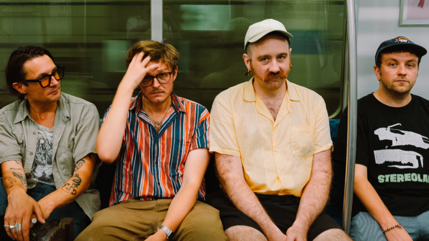 The four members of Yard Act on a subway train