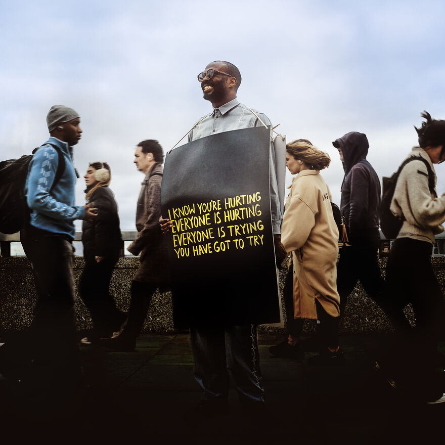 Joshua Idehen wearing a plaque with 