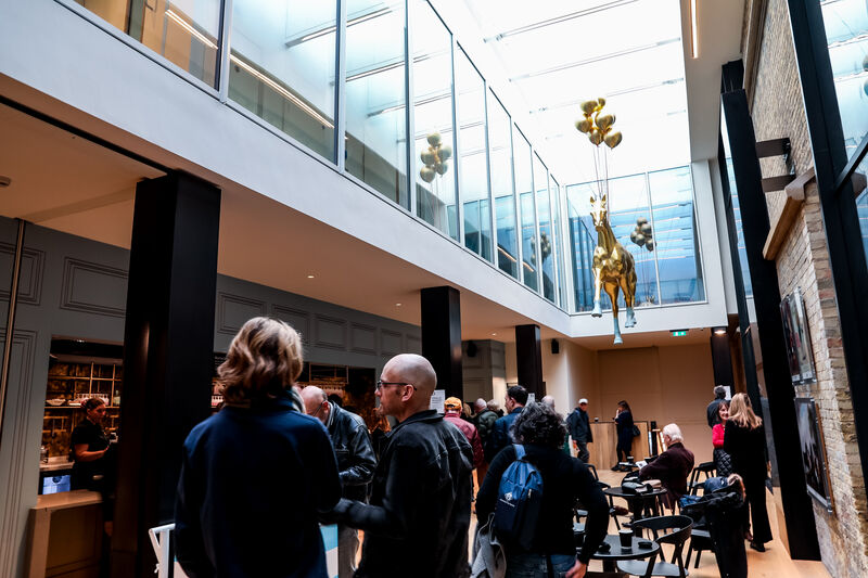 Brighton Dome Gallery Bar filled with people, a gold horse sculpture hangs from the ceiling