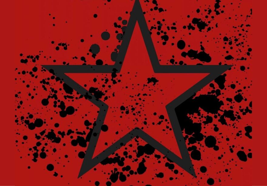 Black star outline surrounded by black splatter on a red background