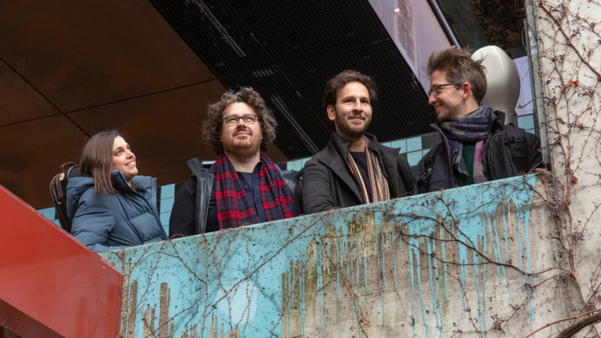 four people together in coats