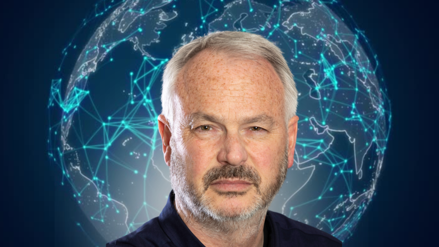 Tim Marshall in front of a pinpointed image of the world