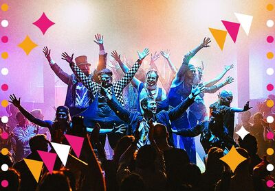 A stylized, colorful image of a large group of people dancing and raising their arms on a brightly lit stage, with a cheering crowd in the foreground. Pink, orange, white, and purple geometric shapes and dots decorate the edges.