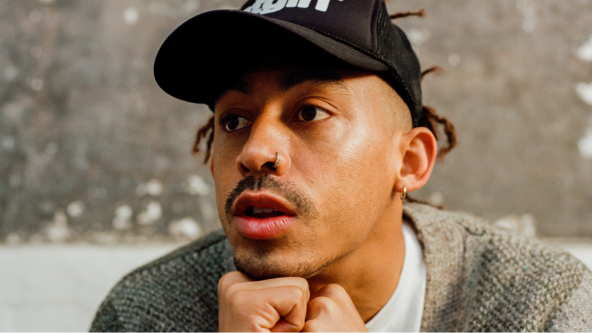 Close up portrait image of Jordan Stephens looking away from camera