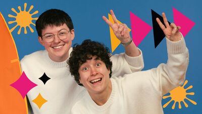 Two people wearing white jumpers smiling and holding up a peace sign. They are surrounded by black, pink and yellow stars, triangles and splashes