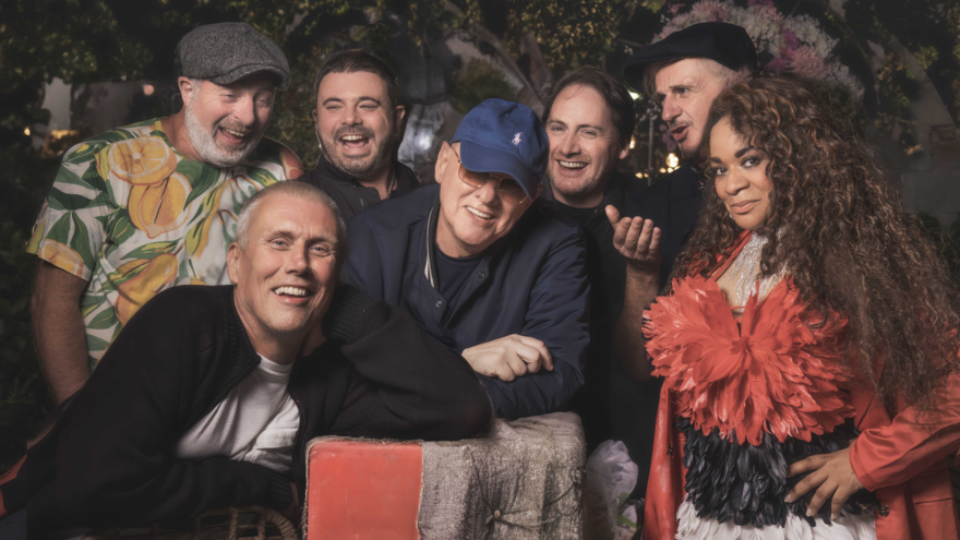 The 7 members of Happy Mondays smiling in a group
