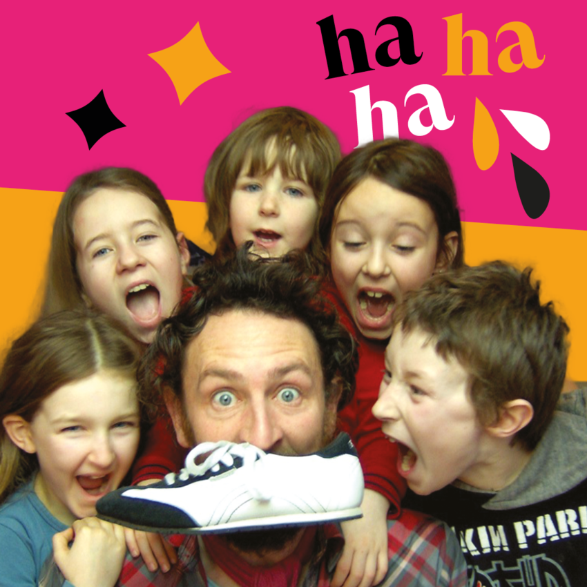 Phil Kay with a shoe in his mouth surrounded by 5 children making faces