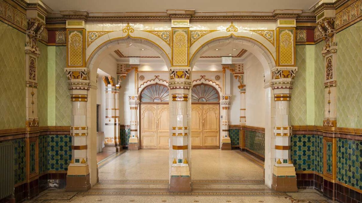 An image of Brighton Dome's entrance way via the West Corridor, with ornate tiling and archways