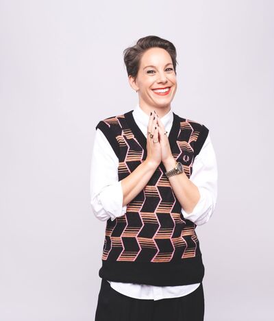 Suzi Ruffel, a white woman with short brown hair and a big smile. 