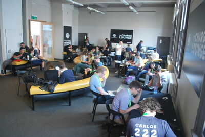 Brighton Dome Founders Room filled with people sitting on chairs and a sofa working on their laptops or phones