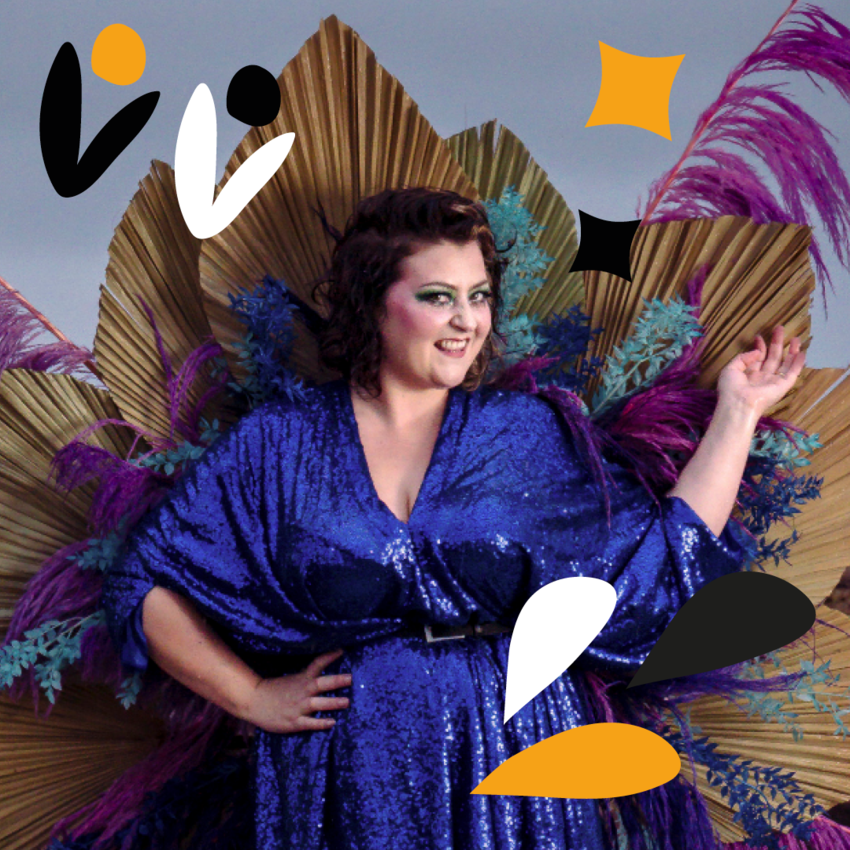 Kiri wearing a sequined blue dress and an accessory like a peacock's feathers