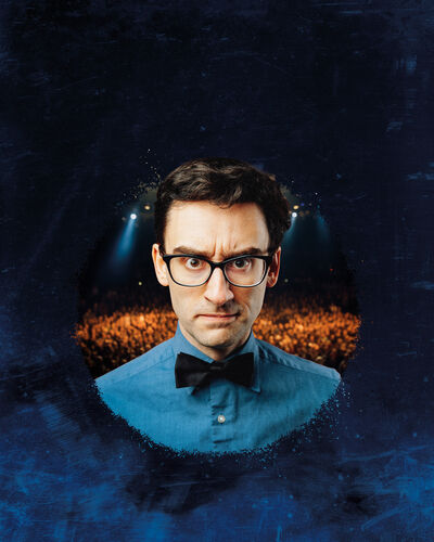Image of MC Hammersmith in a circle wearing a bowtie and blue shirt with an audience behind him