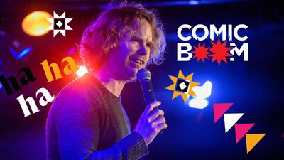 Comedian holding a microphone with Comedy festival graphics and comic boom logo in the background