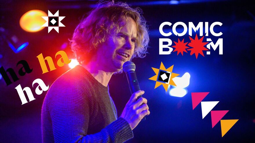 Comedian holding a microphone with Comedy festival graphics and comic boom logo in the background