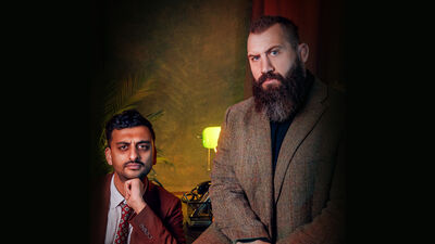 Image of Joe Marler & Jake Bhardwaj sitting in a dimly lit room