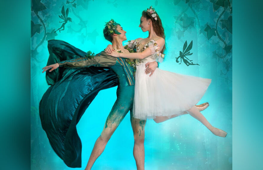 A male ballerina holds a female ballerina in his arms