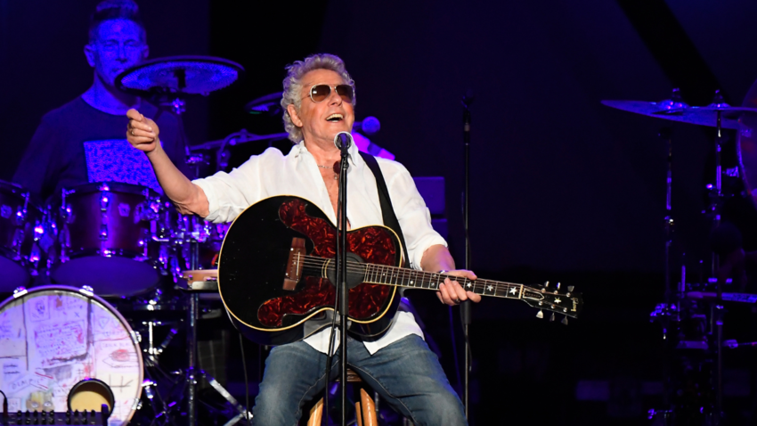 Roger Daltrey on stage playing guitar