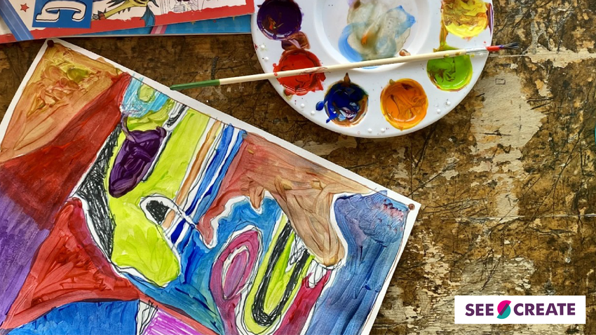 A paining lays on a table surrounded by a paint pallet and paint brush. It is very colourful