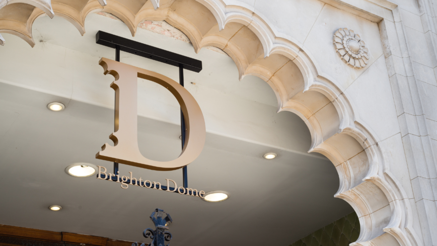 Gold Brighton Dome logo hanging in scalloped archway