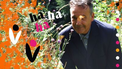 Rob Newman in a field with orange flowers
