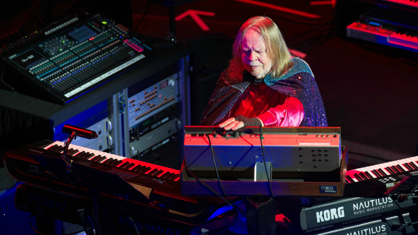 man with long hair is seen with music equipment