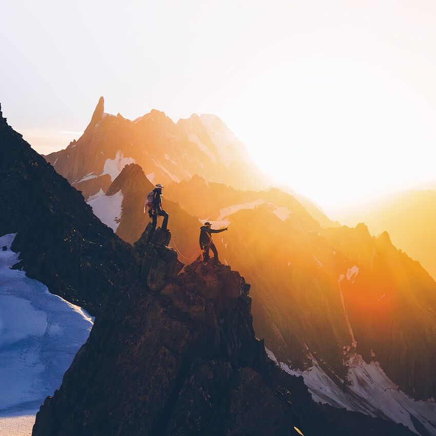 Two hikers on a craggy mountain face