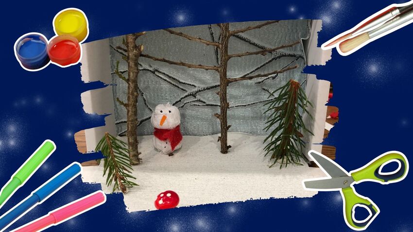 A crafted snow scene with a snowman and trees. The crafted scene is surrounded by a blue border with paints, scissors, brush and pens around.